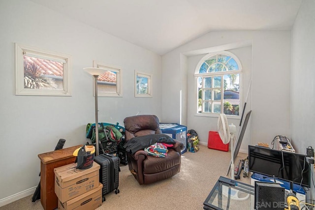 sitting room featuring vaulted ceiling and light carpet