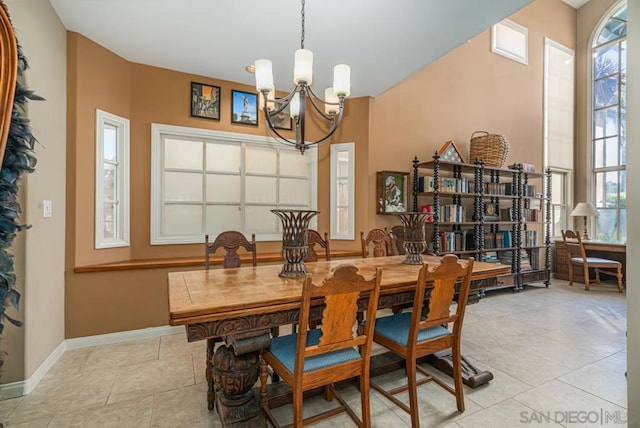 dining room with light tile patterned floors and a chandelier