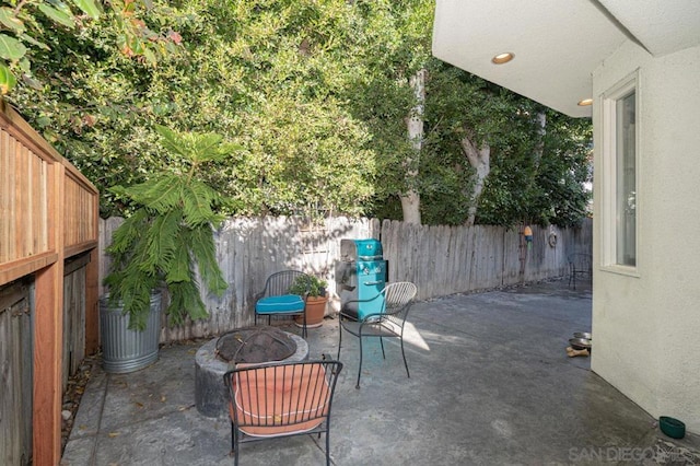 view of patio with a fire pit