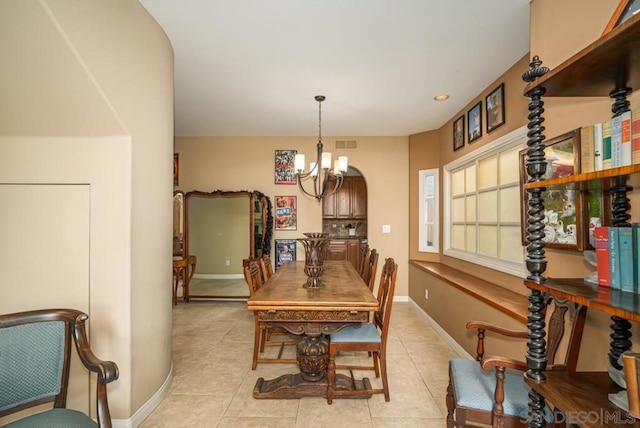 dining area with an inviting chandelier and light tile patterned flooring