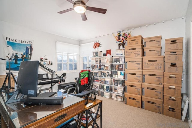 carpeted office space featuring ceiling fan