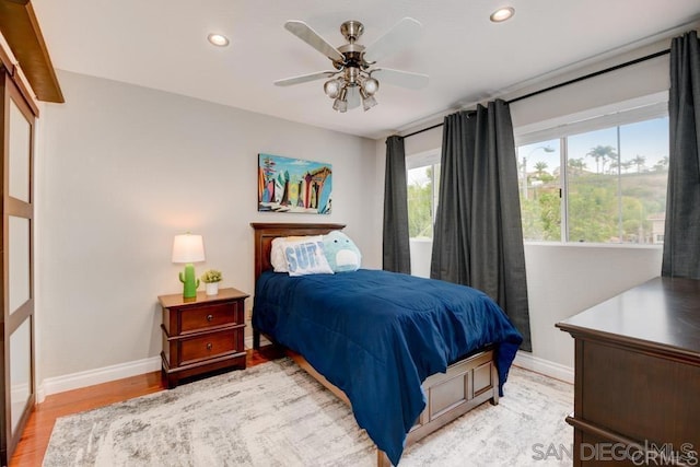 bedroom with ceiling fan and light wood-type flooring