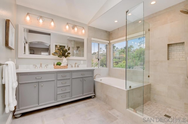 bathroom with vanity, tile patterned flooring, lofted ceiling, and shower with separate bathtub