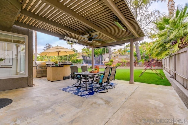 view of patio / terrace featuring exterior kitchen, a trampoline, and grilling area