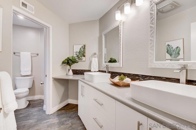 bathroom featuring vanity and toilet