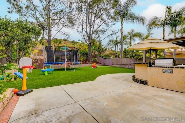 view of patio / terrace with a trampoline and grilling area