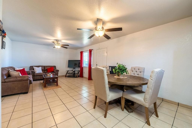 tiled dining space featuring ceiling fan