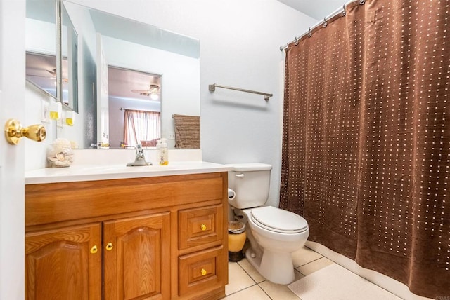 bathroom with a shower with curtain, vanity, tile patterned floors, and toilet