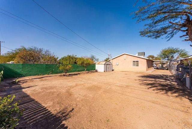 view of yard featuring a patio area and a shed