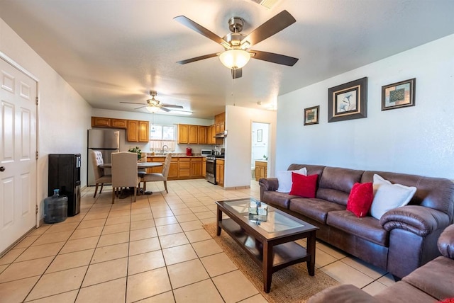 tiled living room with sink and ceiling fan