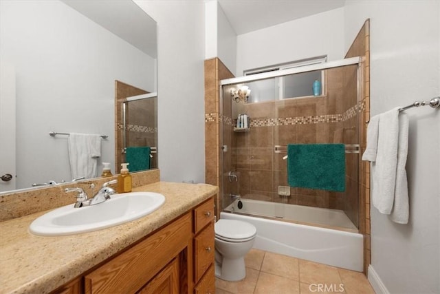 full bathroom featuring vanity, bath / shower combo with glass door, tile patterned floors, and toilet