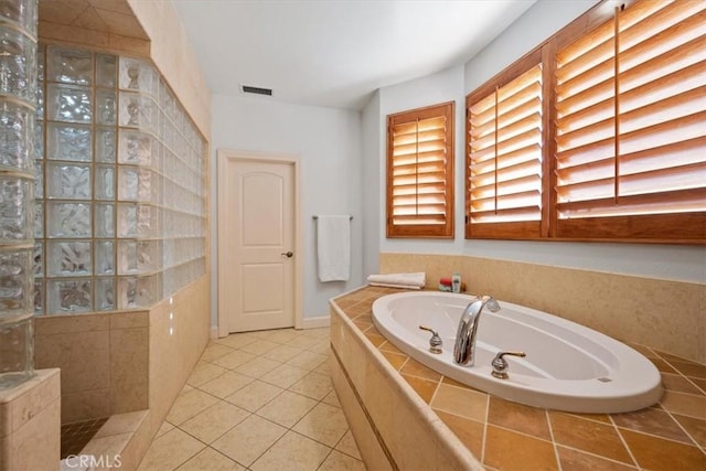 bathroom with plus walk in shower and tile patterned flooring