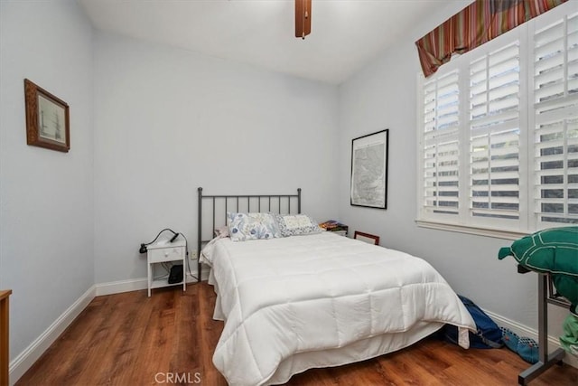 bedroom with dark wood-type flooring and ceiling fan