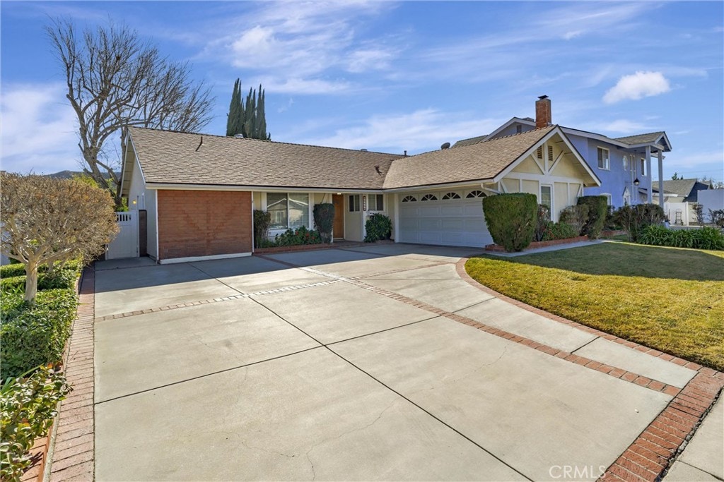 view of front of home with a garage and a front yard