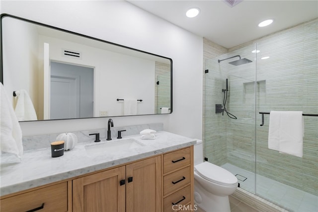 bathroom with recessed lighting, visible vents, toilet, a shower stall, and vanity