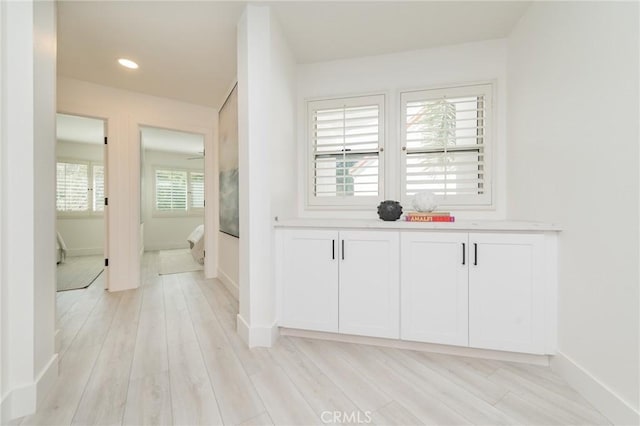 interior space with recessed lighting, wood finished floors, and baseboards