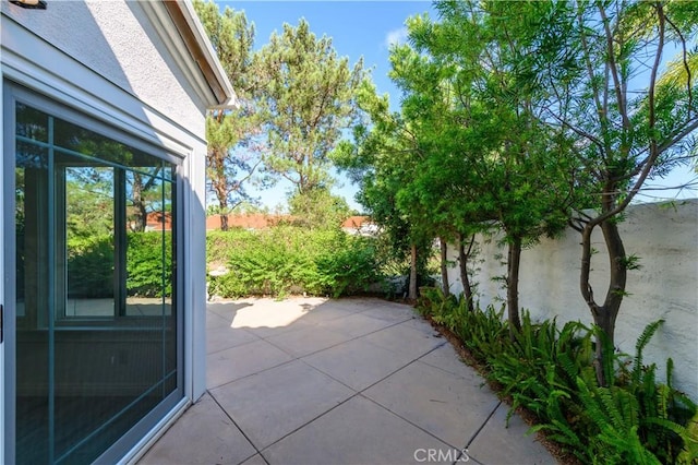 view of patio featuring fence