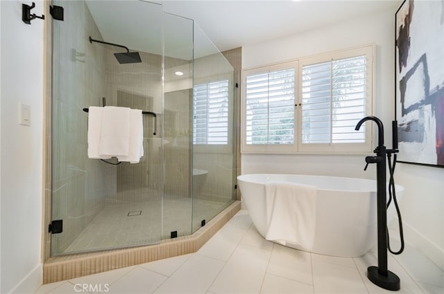 full bath featuring a freestanding bath, a stall shower, and tile patterned flooring