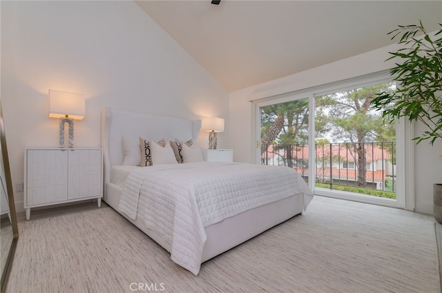 bedroom featuring access to outside and high vaulted ceiling