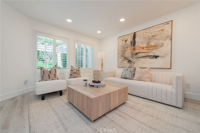 living room featuring recessed lighting, light wood-style flooring, and baseboards