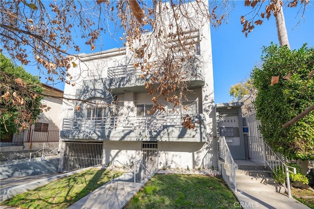 view of front of property with a balcony