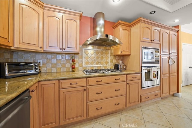 kitchen featuring light tile patterned flooring, appliances with stainless steel finishes, ventilation hood, backsplash, and light stone countertops