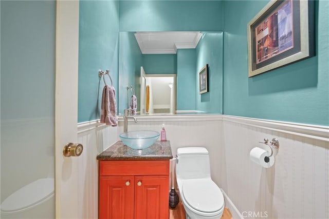 bathroom featuring vanity, ornamental molding, and toilet