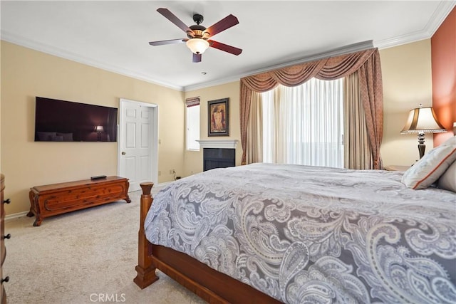 carpeted bedroom featuring ceiling fan and ornamental molding