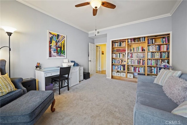 office featuring crown molding, light carpet, and ceiling fan