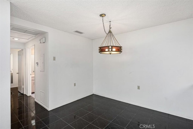 spare room with a textured ceiling