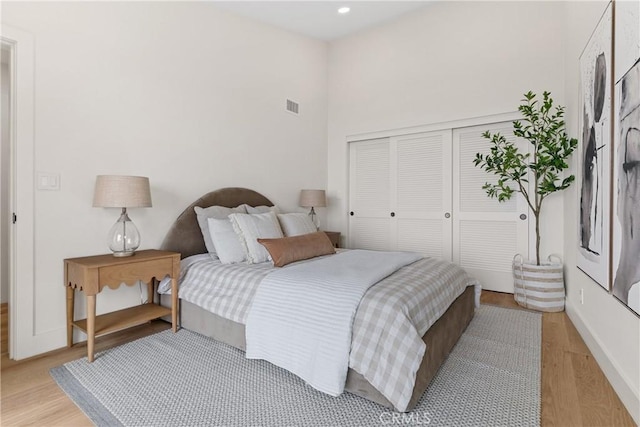 bedroom with light wood-type flooring and a closet