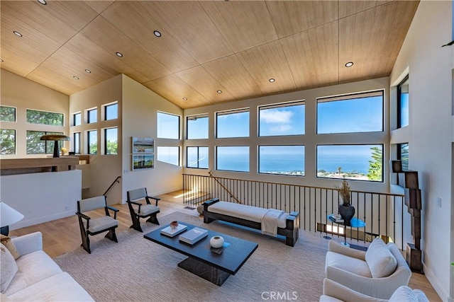 living room with a water view, light wood-type flooring, and wooden ceiling