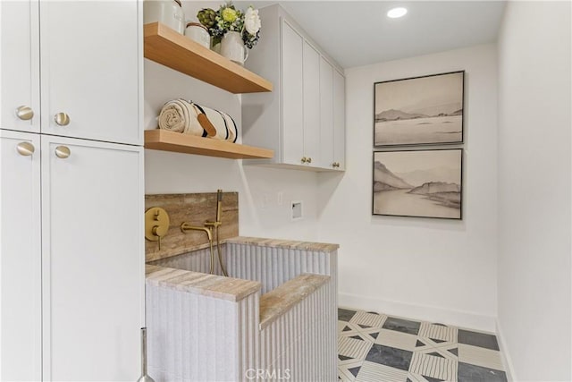 clothes washing area featuring cabinets and washer hookup