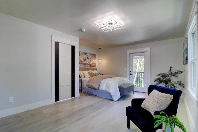 bedroom featuring access to exterior and light hardwood / wood-style floors