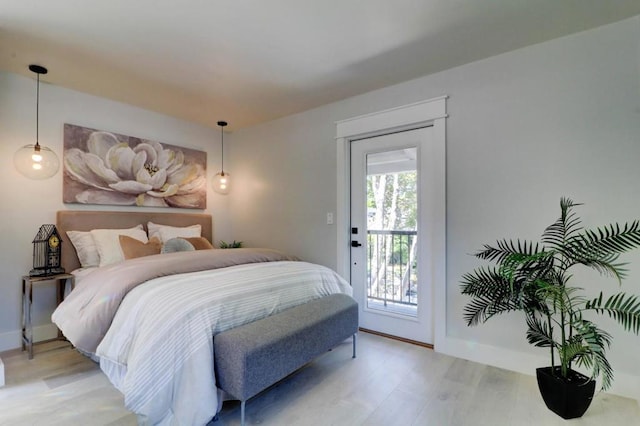 bedroom with access to exterior and light wood-type flooring