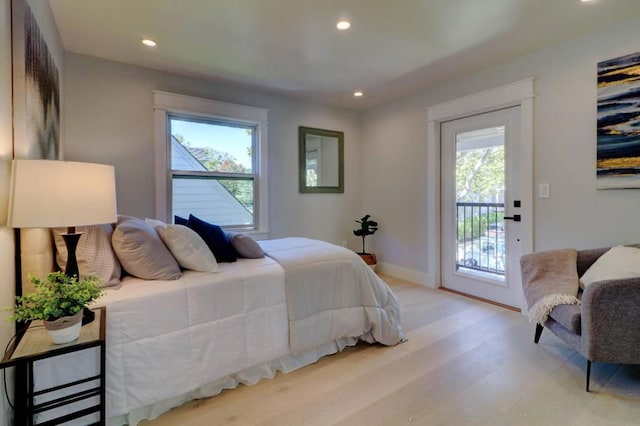 bedroom featuring light hardwood / wood-style flooring and access to outside