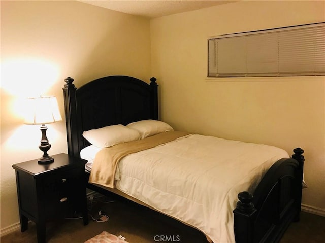 bedroom featuring dark carpet