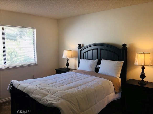 bedroom with multiple windows and a textured ceiling