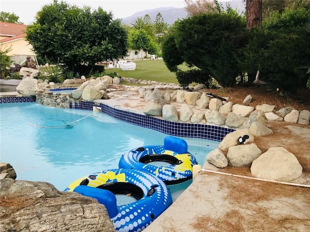 view of swimming pool featuring a mountain view