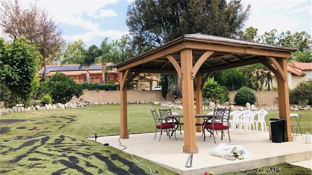 view of home's community with a gazebo, a lawn, and a patio