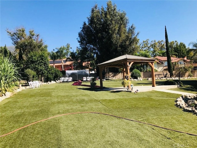 view of home's community with a gazebo and a yard