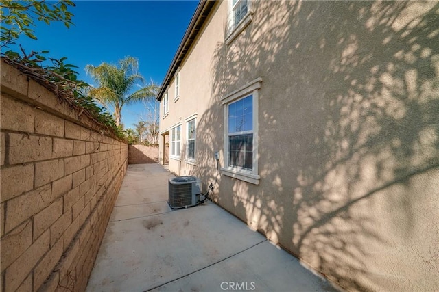 view of home's exterior with a patio and central air condition unit