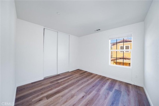 spare room with hardwood / wood-style flooring