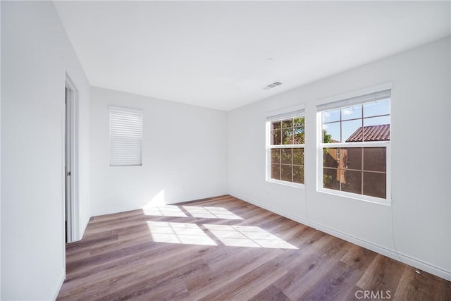 unfurnished room with light hardwood / wood-style flooring