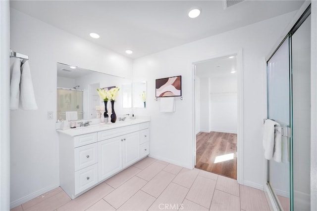 bathroom featuring vanity and a shower with shower door