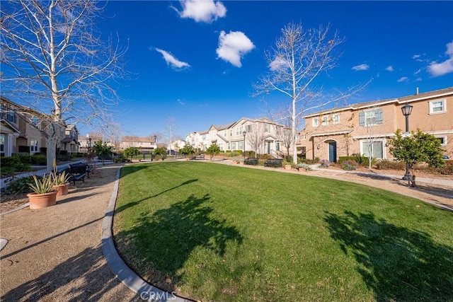 view of property's community with a yard