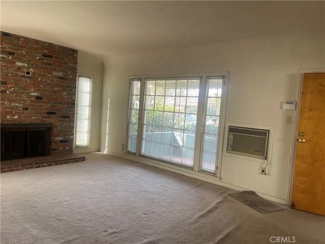 interior space with carpet flooring, a wall mounted air conditioner, and a fireplace