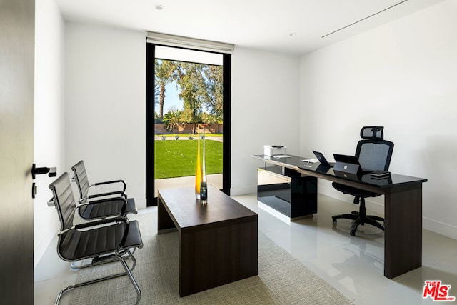 office area with floor to ceiling windows