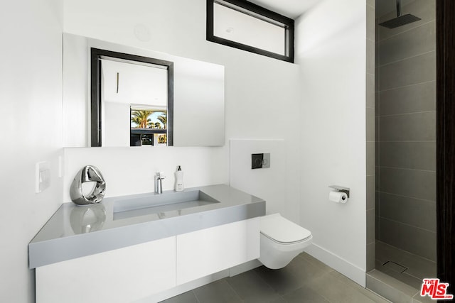 bathroom with walk in shower, vanity, tile patterned floors, and toilet