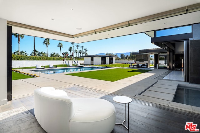 view of patio featuring a fenced in pool and an outbuilding